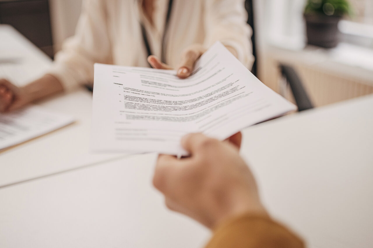 Photo of a person handed over a printed document