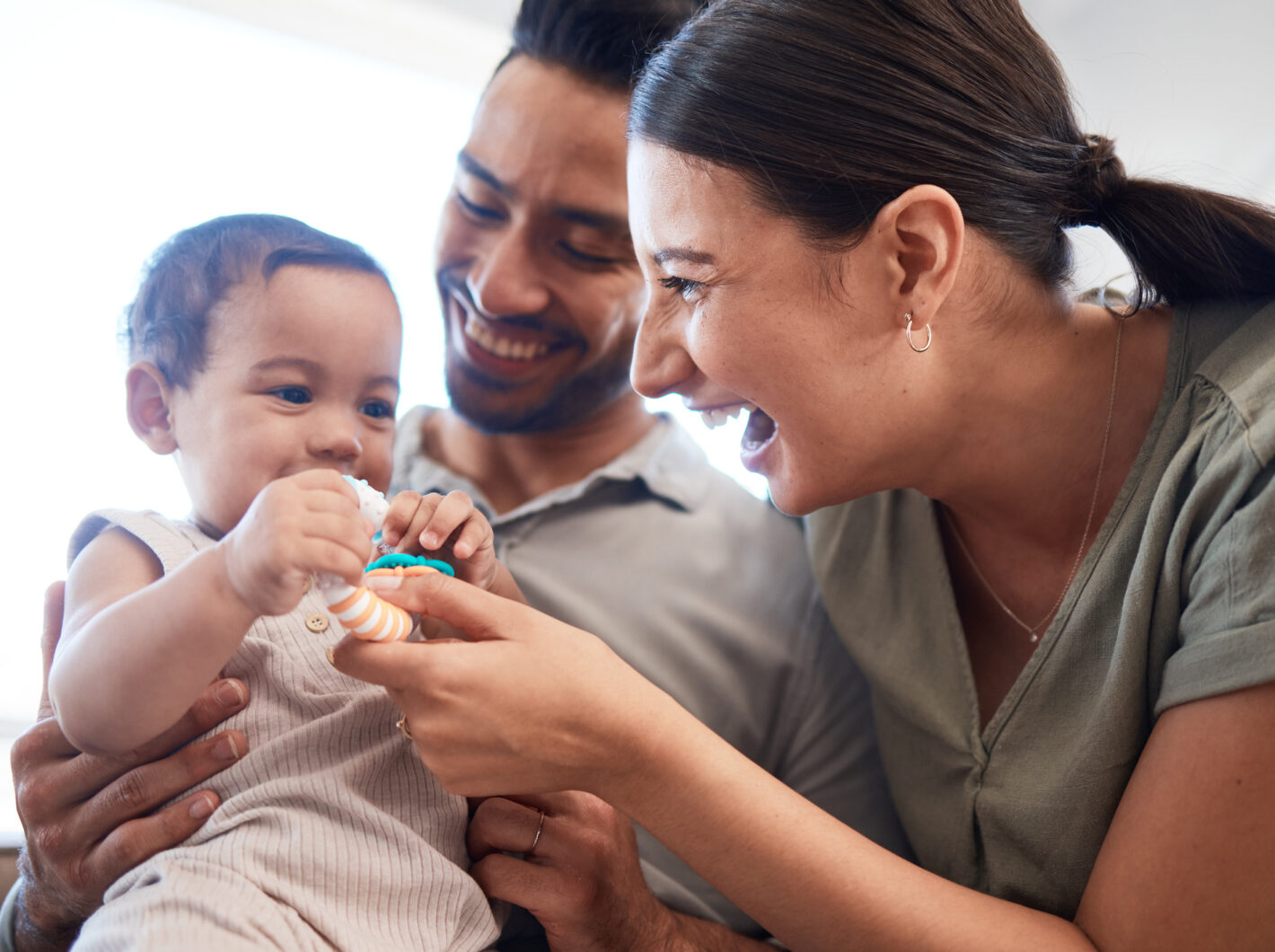 Photo of a couple playing with a baby