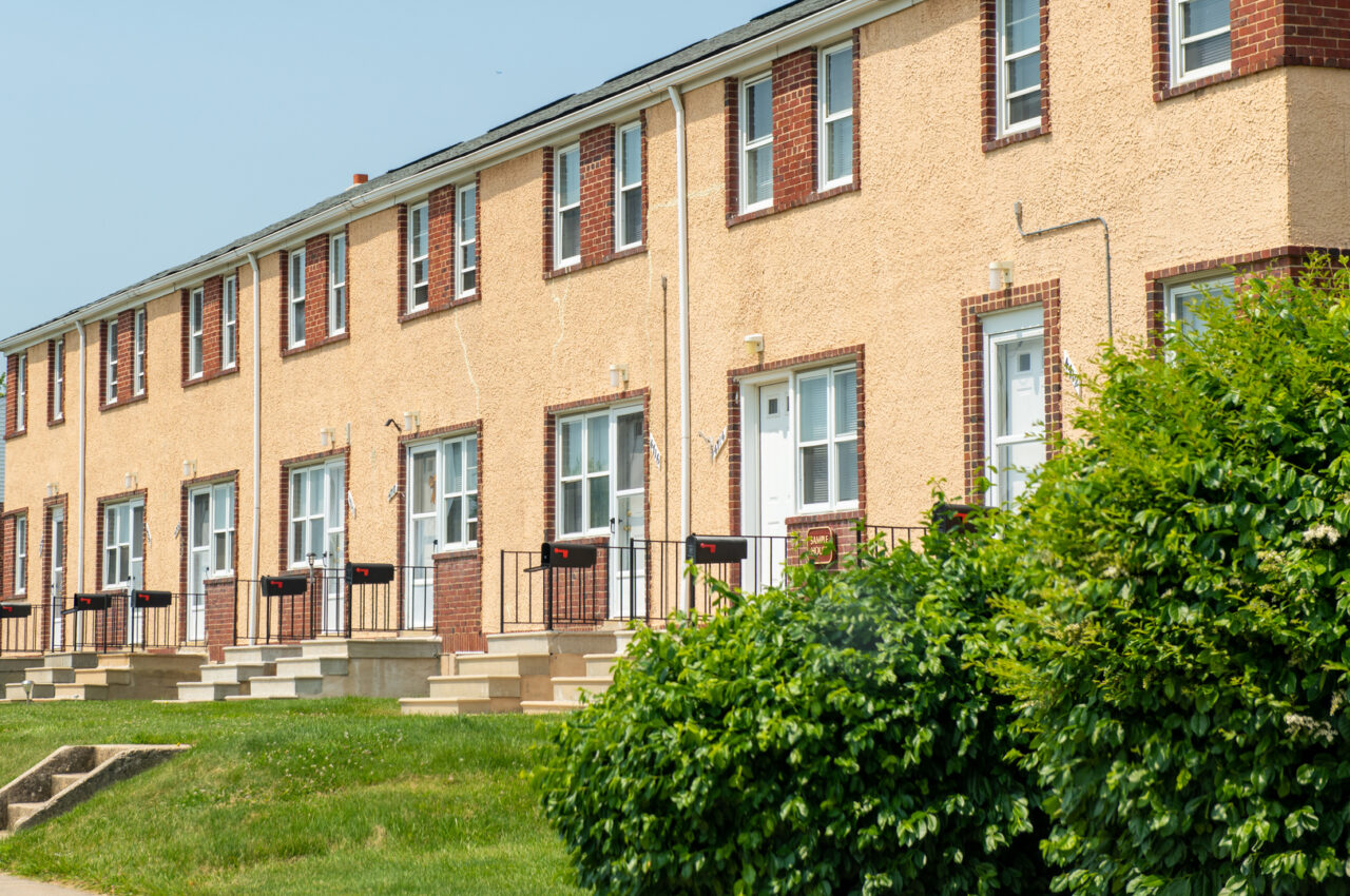 Photo of a row of tan-colored townhomes.
