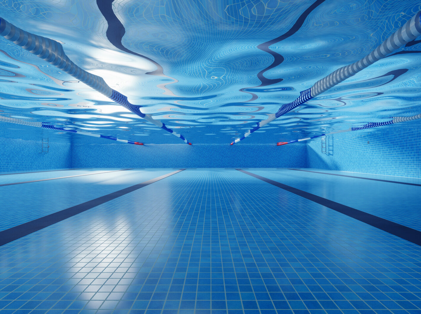 Photo taken underwater of a swimming pool with lane dividers