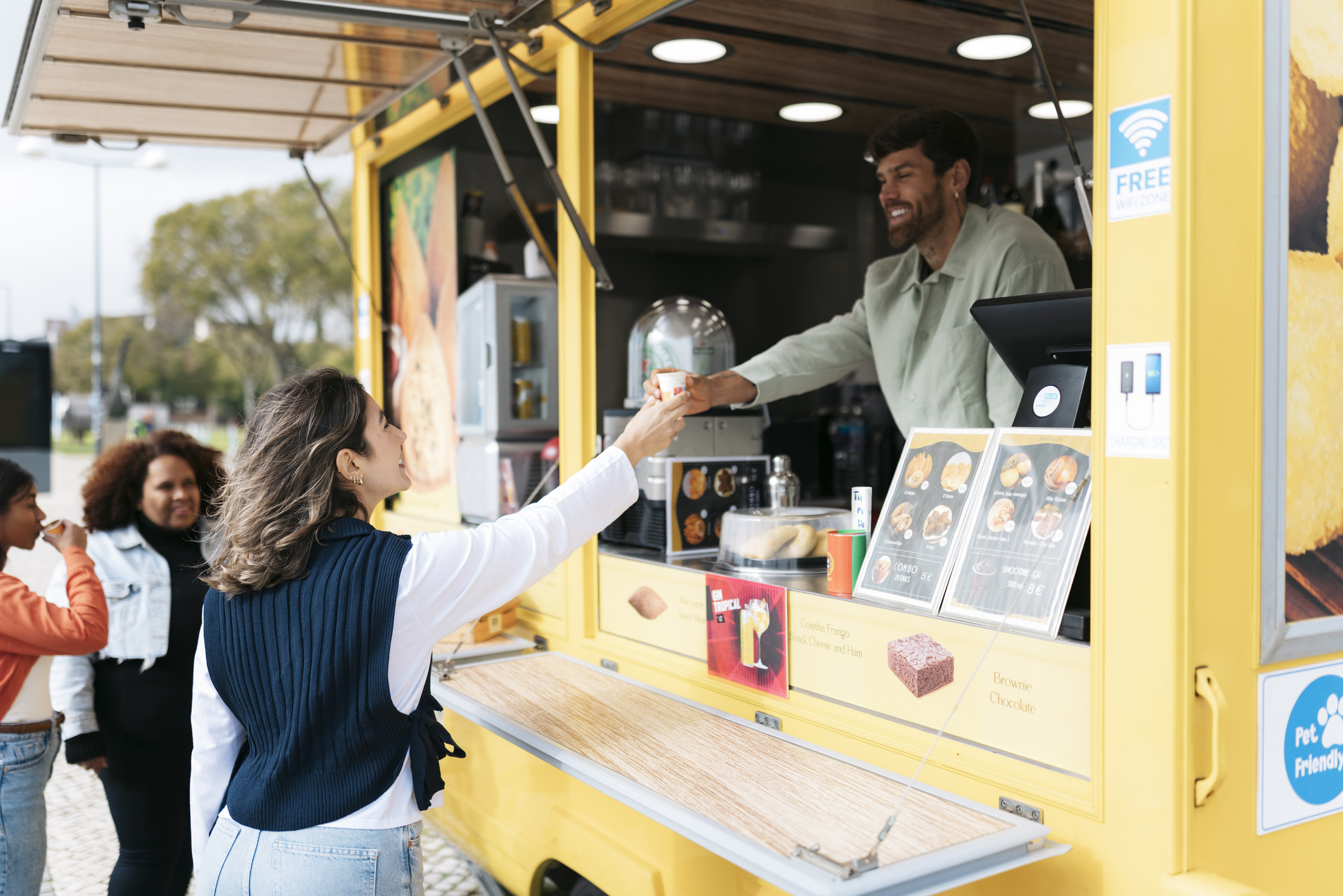 Photo of a woman receiving food from a mobile food truck
